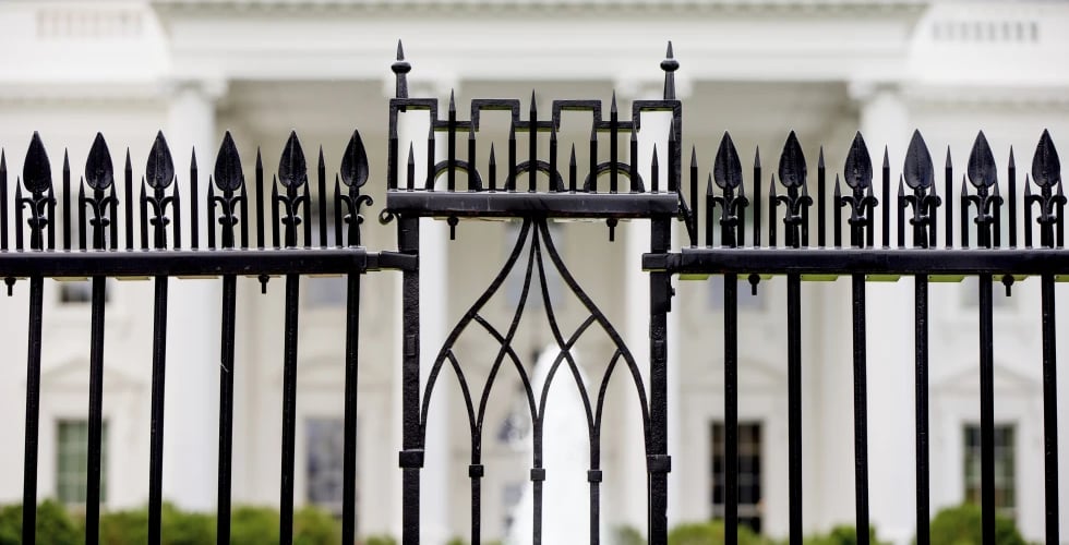 AP : The White House is visible through the fence at the North Lawn in Washington |