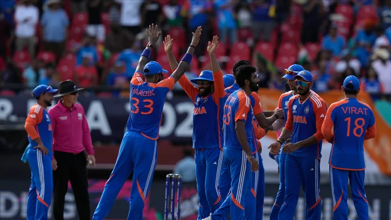 Indian players celebrate a dismissal during the ICC Men's T20 World Cup second semifinal cricket match between England and India at the Guyana National Stadium in Providence, Guyana. - AP Photo/Ramon Espinosa