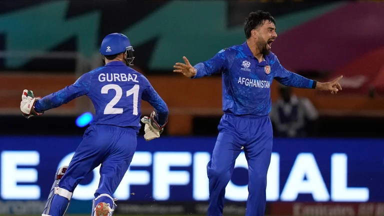 Afghanistan's captain Rashid Khan celebrates after he bowled New Zealand's Mark Chapman during an ICC Men's T20 World Cup cricket match at Guyana National Stadium in Providence, Guyana, Friday, June 7, 2024. -  (AP Photo/Ramon Espinosa)