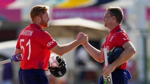 Photo: AP/PTI : England's captain Jos Buttler, right, and batting partner Jonny Bairstow shake hands at the end of the ICC Men's T20 World Cup cricket match against Oman at Sir Vivian Richards Stadium in North Sound, Antigua and Barbuda.