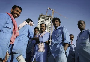 Getty Images : Indian expatriate construction workers from Madras are seen in front of a building under construction in the Dubai (representative image)