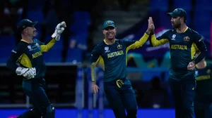 AP Photo/Ricardo Mazalan : Australia's Glenn Maxwell, right, celebrates with teammates David Warner and wicketkeeper Matthew Wade after taking the catch to dismiss Namibia's Michael Van Lingen for 10 runs during an ICC Men's T20 World Cup cricket match at Sir Vivian Richards Stadium in North Sound, Antigua and Barbuda.
