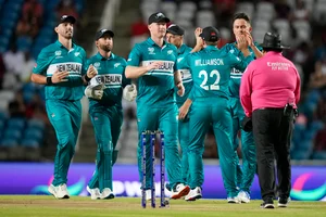 (AP Photo/Ramon Espinosa) : New Zealand players celebrate the dismissal of West Indies' Johnson Charles during the men's T20 World Cup cricket match between the West Indies and New Zealand at the Brian Lara Cricket Academy, Tarouba, Trinidad and Tobago, Wednesday, June 12, 2024. 