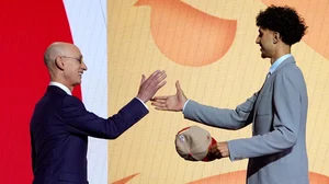 No. 1 overall pick Zaccharie Risacher shakes hands with NBA Commissioner Adam Silver.