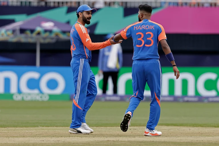 India's Hardik Pandya, right, celebrates with teammate Virat Kohli after the dismissal of United States' captain Aaron Jones during the ICC Men's T20 World Cup cricket match between United States and India at the Nassau County International Cricket Stadium in Westbury, New York, Wednesday, June 12, 2024.  - (AP Photo/Adam Hunger)
