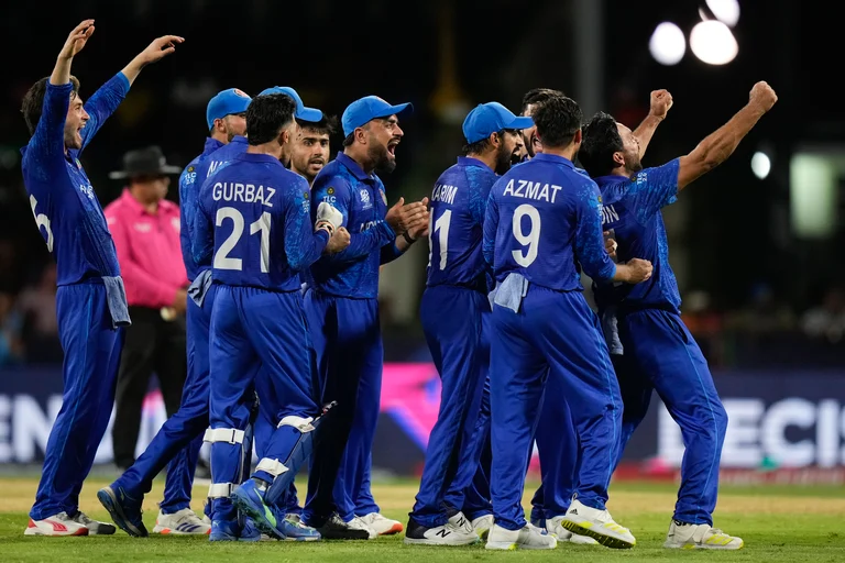 Afghanistan players celebrate the dismissal of Australia's Tim David during the men's T20 World Cup cricket match between Afghanistan and Australia at Arnos Vale Ground, Kingstown, Saint Vincent and the Grenadines, Saturday, June 22, 2024. 
 - (AP Photo/Ramon Espinosa)
