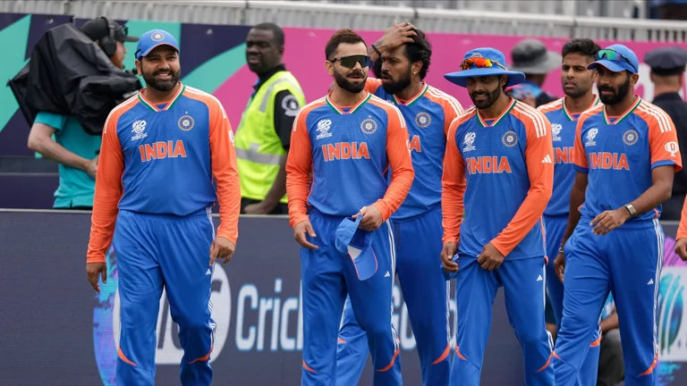 India's captain Rohit Sharma, left, leads his team to the field at the Nassau County International Cricket Stadium. - AP
