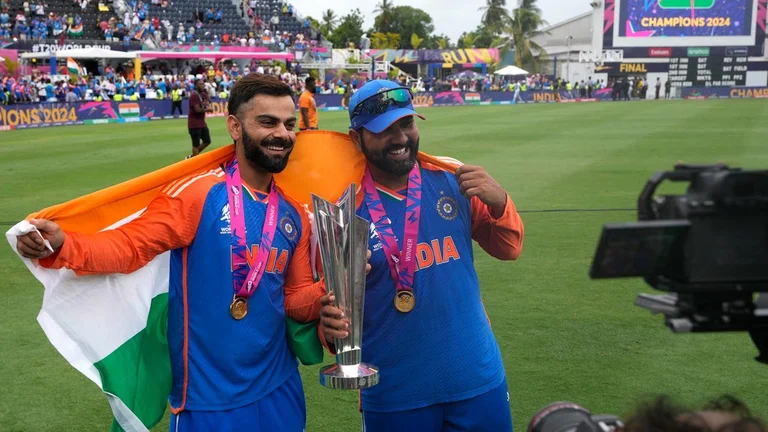 Virat Kohli and Rohit Sharma celebrate with the ICC T20 World Cup 2024 trophy after India beat South Africa in the final, in Barbados on Saturday (June 29). - AP/Ricardo Mazalan