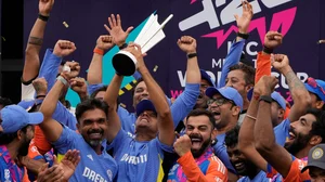 AP Photo/Ricardo Mazalan : India's head coach Rahul Dravid, center left, and Virat Kohli, center right, celebrate with players and team support staff with the winners trophy after defeating South Africa in the ICC Men's T20 World Cup final cricket match at Kensington Oval in Bridgetown, Barbados.