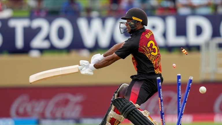 Papua New Guinea's Sese Bau is bowled by West Indies' Alzarri Joseph during an ICC Men's T20 World Cup cricket match at Guyana National Stadium in Providence, Guyana, Sunday, June 2, 2024. 
 - (AP Photo/Ramon Espinosa)