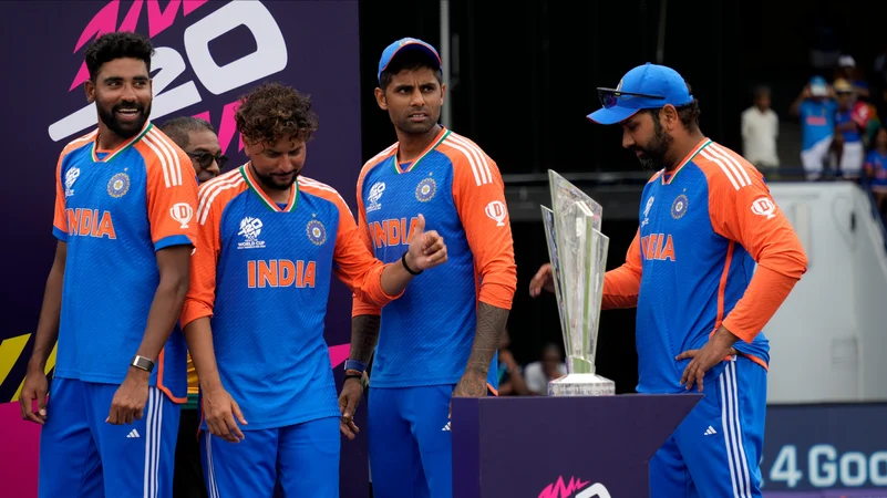 Rohit Sharma and teammates Suryakumar Yadav, Kuldeep Yadav and Mohd Siraj stand next to the winners trophy. AP Photo