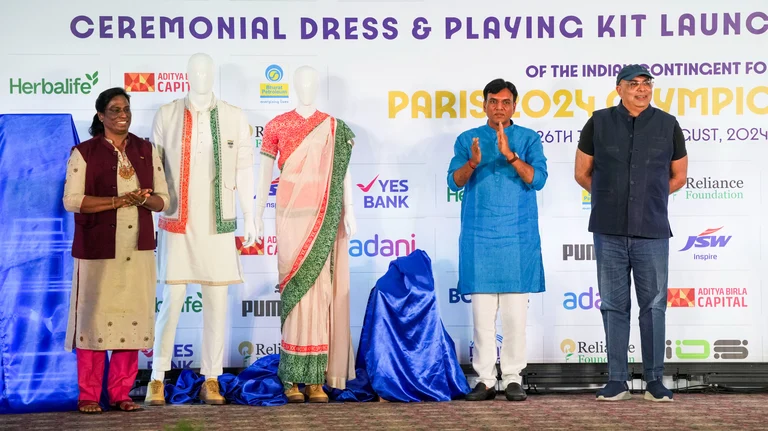 Union Minister of Youth Affairs and Sports Mansukh Mandaviya and IOA Chief PT Usha during the launch of the ceremonial dress and playing kit for the upcoming Paris Olympics. - PTI Photo/Arun Sharma