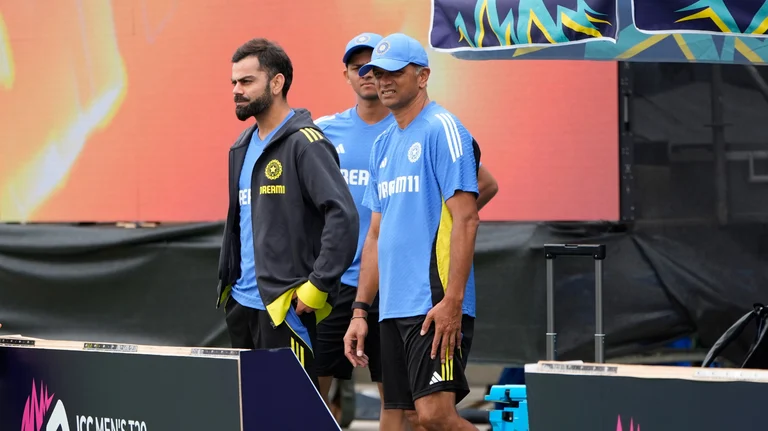 Indian team head coach Rahul Dravid, right, and Virat Kohli, left, walk into the ground after the ICC Men's T20 World Cup cricket match between Canada and India was called off due to the wet outfield at the Central Broward Regional Park Stadium in Lauderhill. - Photo: X/ AP/PTI