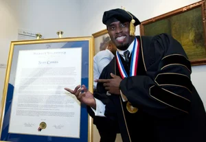 X : Sean "Diddy" Combs with his honorary degree awarded by Howard University in 2014.