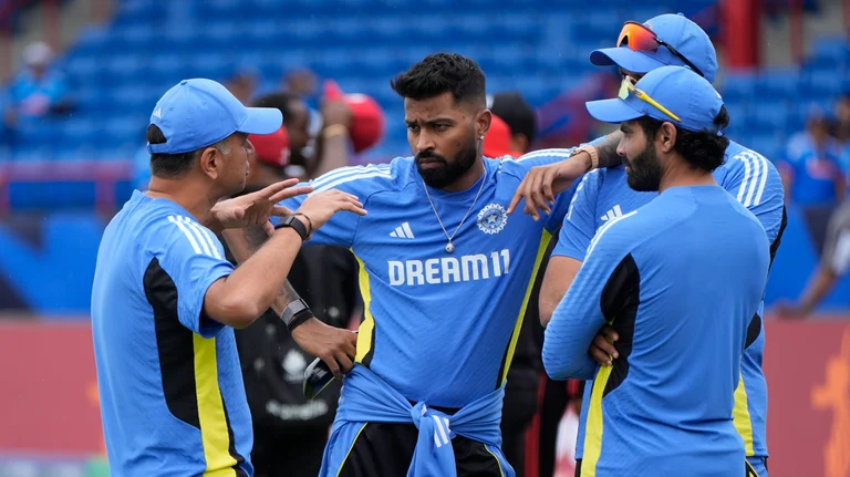 Indian team head coach Rahul Dravid, left, speaks to the players ahead of the ICC Men's T20 World Cup cricket match between Canada and India at the Central Broward Regional Park Stadium, Lauderhill, Fla., Saturday, June 15, 2024. -  (AP Photo/Lynne Sladky)