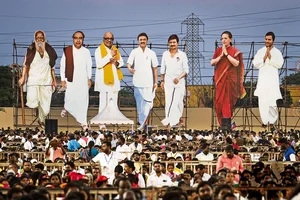 Photo: AP : Joining Hands: Large cutouts of DMK and Congress leaders loom over a campaign rally venue at the outskirts of Chennai ahead 
of the Lok Sabha elections