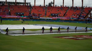 AP/Ramon Espinosa : Groundsmen move the covers after wet outfield delayed the toss for the ICC Men's T20 World Cup second semifinal cricket match between England and India at the Guyana National Stadium in Providence, Guyana, Thursday, June 27, 2024.

