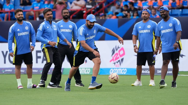 India's captain Rohit Sharma, third right, plays with a soccer ball as wet outfield delayed the start of the ICC Men's T20 World Cup cricket match between Canada and India at the Central Broward Regional Park Stadium, Lauderhill, Fla., Saturday, June 15, 2024. - AP Photo/Lynne Sladky