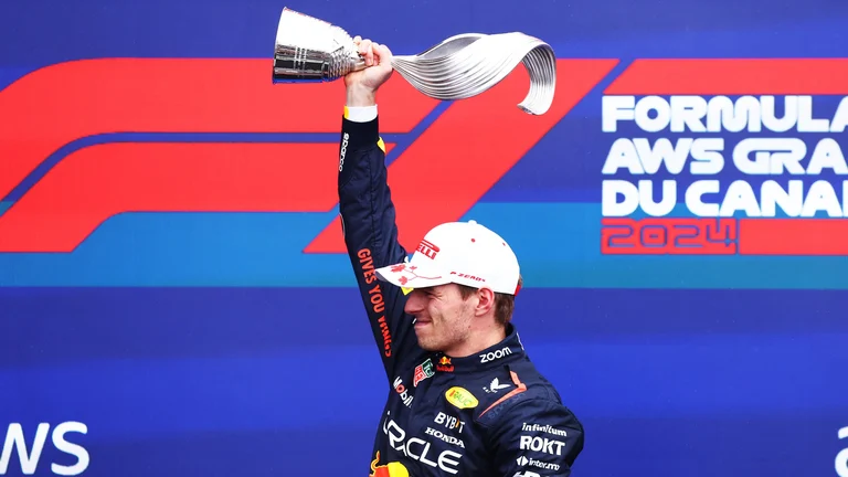 Max Verstappen holds the Canadian Grand Prix trophy aloft - null
