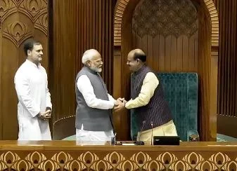 PM Modi, with the Leader of Opposition Rahul Gandhi standing behind him, shakes hand with Lok Sabha Speaker Om Birla | - x/Screengrab from Sansad TV video posted by ANI 