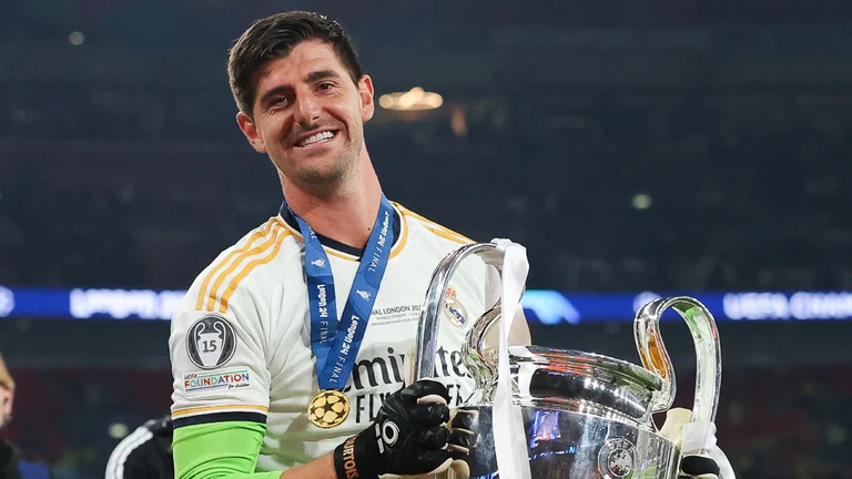 Thibaut Courtois with the Champions League trophy - null