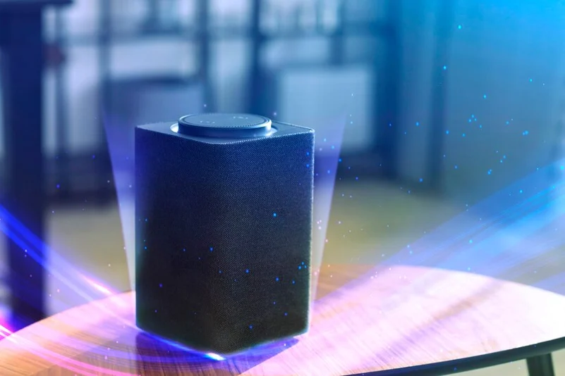 A Bluetooth speaker on a table with sound waves 