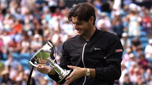 Taylor Fritz poses with the Eastbourne International trophy