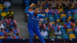 AP Photo/Ricardo Mazalan : Afghanistan's captain Rashid Khan reacts after bowling a delivery during the ICC Men's T20 World Cup cricket match between Afghanistan and India at Kensington Oval in Bridgetown, Barbados.