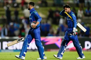 (AP Photo/Ricardo Mazalan) : Afghanistan's Naveen-ul-Haq an teammate Fazalhaq Farooqi walk from the field after they were dismissed for 56 runs during the men's T20 World Cup semifinal cricket match between Afghanistan and South Africa at the Brian Lara Cricket Academy in Tarouba, Trinidad and Tabago, Wednesday, June 26, 2024. 