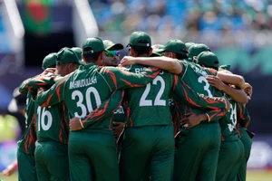  (AP Photo/Adam Hunger) : Bangladesh players huddle before the start of the ICC Men's T20 World Cup cricket match between Bangladesh and South Africa at the Nassau County International Cricket Stadium in Westbury, New York, Monday, June 10, 2024.
