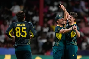 AP/Ramon Espinosa : Pat Cummins celebrates his hat-trick with teammates during the Afghanistan vs Australia, ICC T20 World Cup 2024 match in St Vincent on Sunday (June 23).