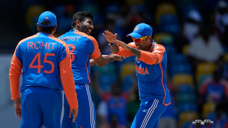 bumrah, sky and rohit celebrating a wicket. AP Photo