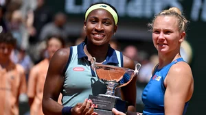 Coco Gauff and Katerina Siniakova hold the French Open women's doubles trophy