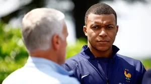 (Sarah Meyssonnier/Pool Photo via AP)
 : French soccer player Kylian Mbappe, right, listening to head coach Didier Deschamps at the national soccer team training center in Clairefontaine, west of Paris, Monday, June 3, 2024 ahead of the UEFA Euro 2024. 

