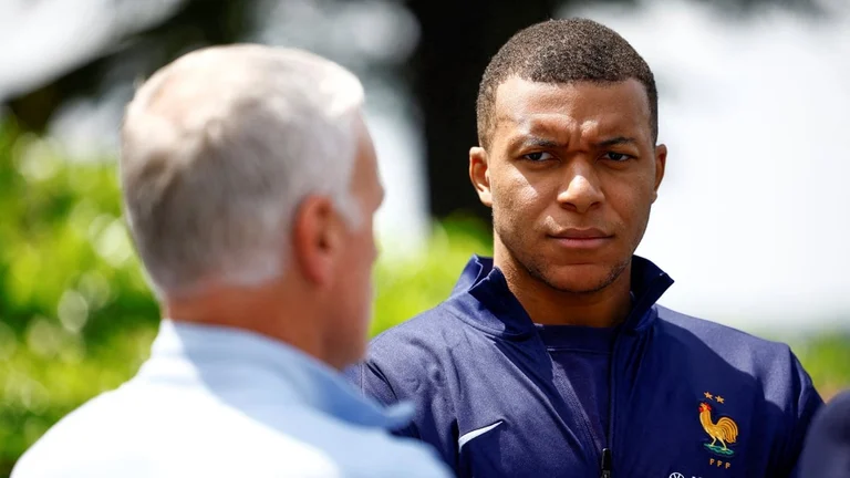 French soccer player Kylian Mbappe, right, listening to head coach Didier Deschamps at the national soccer team training center in Clairefontaine, west of Paris, Monday, June 3, 2024 ahead of the UEFA Euro 2024. 

 - (Sarah Meyssonnier/Pool Photo via AP)
