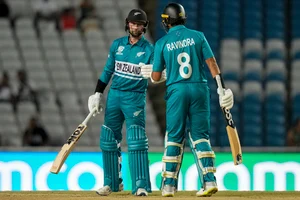 (AP Photo/Ramon Espinosa) : New Zealand's Devon Conway, left, is congratulated by batting partner Rachin Ravindra, right, after playing a shot against Uganda during an ICC Men's T20 World Cup cricket match at the Brian Lara Cricket Academy in Tarouba, Trinidad and Tobago, Friday, June 14, 2024. 

