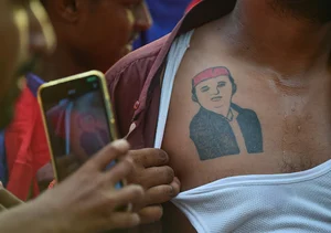 (Photo by Ritesh Shukla/Getty Images) : A tattoo of Akhilesh Yadav is seen on the chest of a Samajwadi Party Supporter celebrating after counting of votes began for India's general election, at the Samajwadi Party Office on June 04, 2024 in Lucknow,