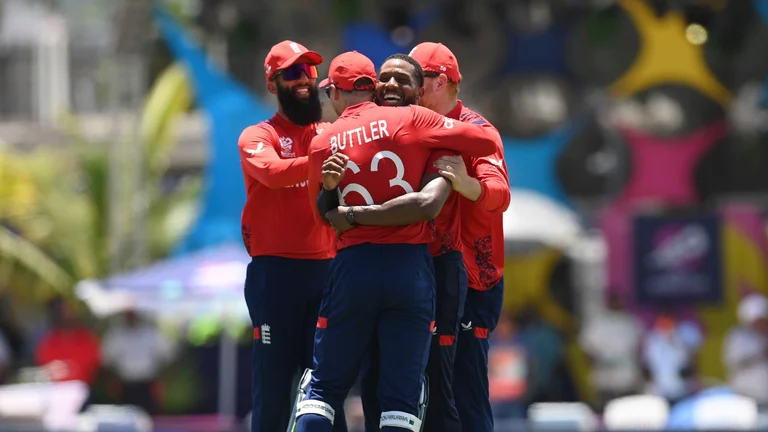 Jos Buttler and Chris Jordan celebrate the latter's hat-trick on Sunday. - null