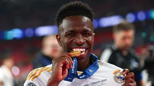 Vinicius Junior celebrates with his second Champions League winners' medal.