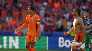 AP Photo/Sunday Alamba : Virgil van Dijk of the Netherlands (4) and teammates walk off the field following a Group D match against Austria at the Euro 2024 soccer tournament in Berlin, Germany.