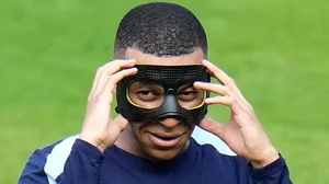 (AP Photo/Hassan Ammar) : FILE - France's Kylian Mbappe gestures as he adjusts his face mask during a training session in Paderborn, Germany, on June 27, 2024. Kylian Mbappé has had more masks than goals at Euro 2024. Widely regarded as the heir to Lionel Messi and Cristiano Ronaldo as soccer's biggest icon, the France striker is struggling with his peripheral vision due to the protective face covering he has been fitted with since breaking his nose at the start of the European Championship. 