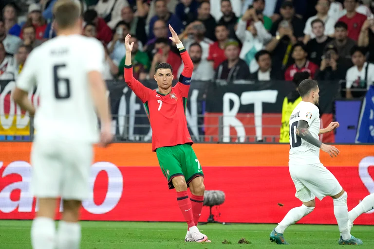 Portugal's Cristiano Ronaldo, right, reacts during a round of sixteen match between Portugal and Slovenia at the Euro 2024 soccer tournament in Frankfurt, Germany, Monday, July 1, 2024.  - (AP Photo/Michael Probst)