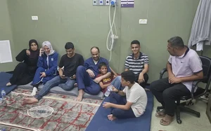 AP : This image shows Mohammed Abu Selmia, director of Gaza's al-Shifa hospital, with his family after release |