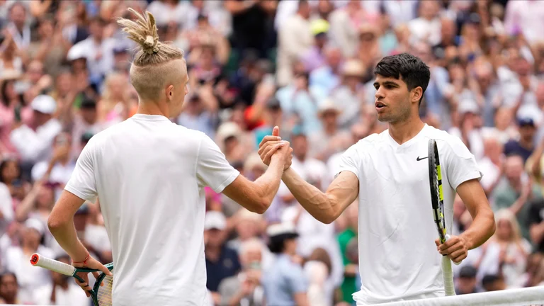 Carlos Alcaraz, right, of Spain is congratulated Mark Lajal of Estonia following their first round match at the Wimbledon tennis championships in London, Monday, July 1, 2024.  - (AP Photo/Alberto Pezzali)