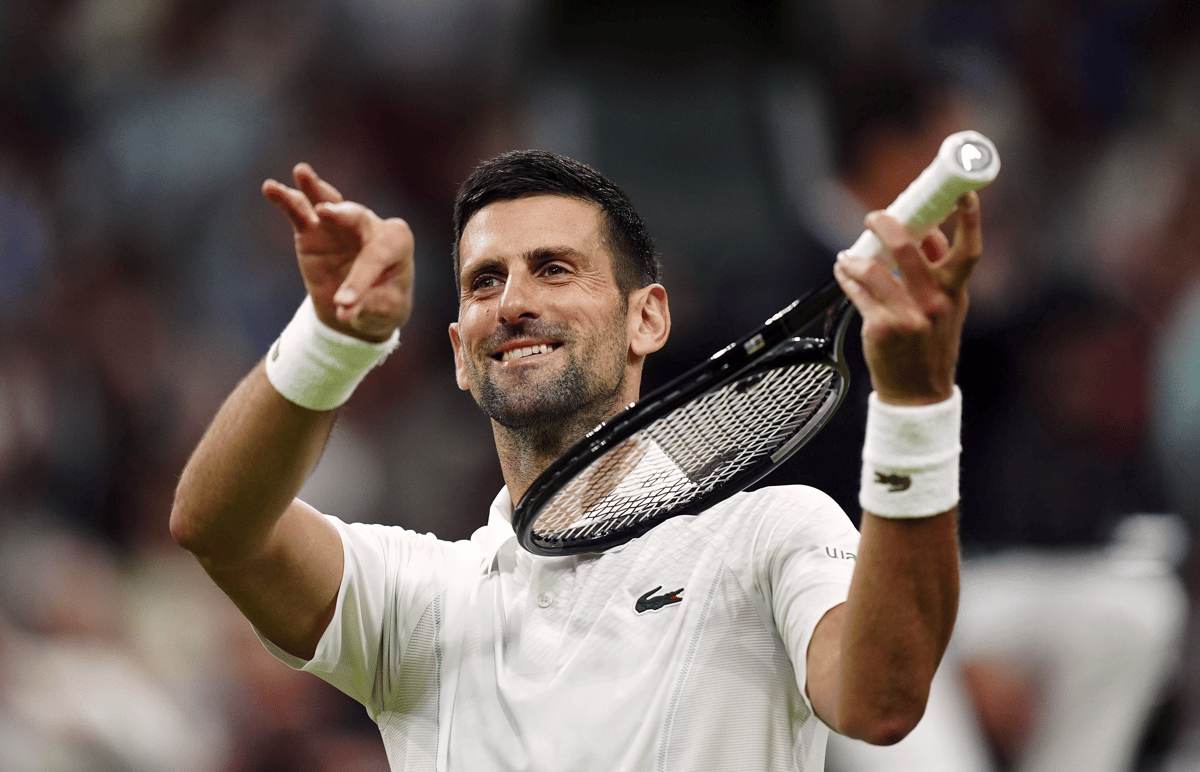 Mike Egerton/PA via AP : Novak Djokovic of Serbia pretends to play a violin after defeating Holger Rune of Denmark in their fourth-round match at Wimbledon 2024 in London, Monday, July 8, 2024.