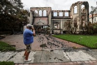 | Photo: AP/Mike Carlson : Hurricane Helene: Joe Daum looks at the remains of a friend's home 