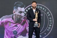 | Photo: Matias J. Ocner/Miami Herald via AP : Lionel Messi holds the MARCA America Award