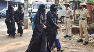 Muslim schoolgirls protest outside a police station, demanding an apology from BJP MLA Balmukund Acharya, who objected to their wearing hijab during a school event.