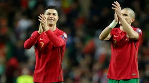 Portugal's Cristiano Ronaldo (L) and Pepe celebrate after beating North Macedonia in WC playoffs.