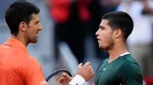 Novak Djokovic (L) shakes hands with Carlos Alcaraz after Madrid Open 2022 semifinal.